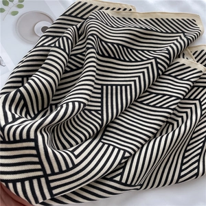 Close-up of black and white geometric stripe patterns on fine knit scarf fabric