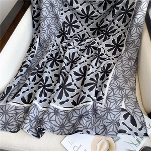Close-up of black and white floral print cotton linen scarf on an armchair