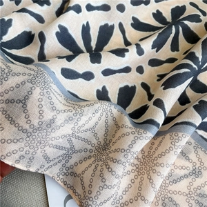 Detailed close-up of soft floral pattern fabric with elegant drape and silky texture