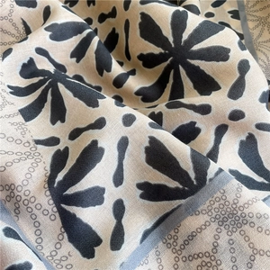 Detail of soft cotton linen shawl with abstract floral prints and chain patterns