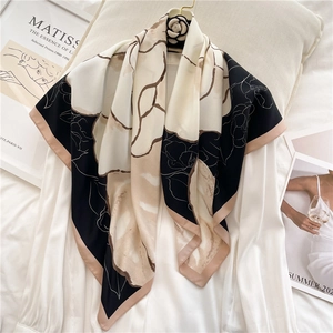 Elegant camellia silk scarf 90x90cm with artistic floral pattern on white shirt