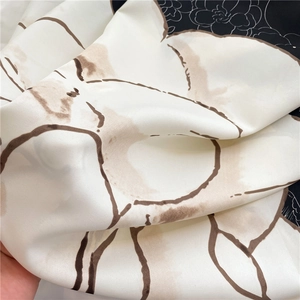 Detail of camellia silk scarf showing matte twill texture and floral print patterns