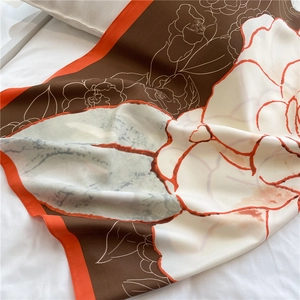 Detailed close-up of camellia floral pattern on 90x90cm silk scarf with matte texture