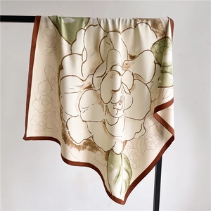 90x90cm camellia silk scarf in vintage beige and brown, elegantly draped on a black hanger