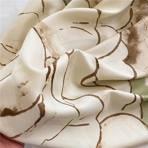 Close-up of camellia pattern silk scarf showing soft matte texture and floral detail