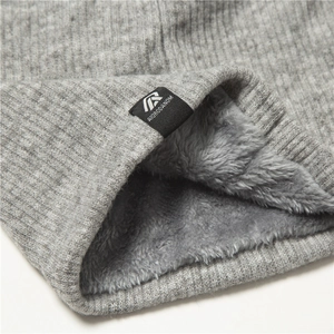 Detail of grey knitted neck gaiter with thick fleece lining and brand woven label