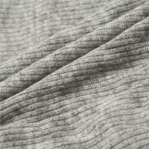 Close-up of grey ribbed knit fabric showing vertical texture and soft warm material