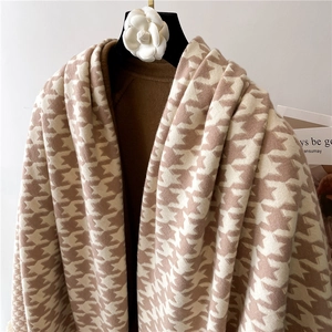 Detail of winter houndstooth scarf showing soft cashmere-like texture and frayed edges