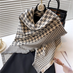 Detail of grey houndstooth scarf with soft fringes on a minimalist lifestyle setting