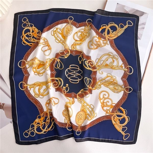 Detail of vintage navy and gold equestrian chain pattern on smooth silk square scarf