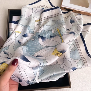 Elegant lotus flower silk scarf in blue and cream white with delicate floral pattern