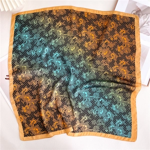 Close-up of lace paisley pattern and gradient silk fabric with golden borders