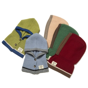 Close-up of knit balaclava hoods in various colors with button details and woven labels