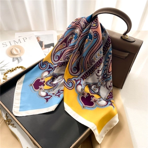 European paisley silk scarf for women, colorful luxury shawl draped on a handbag