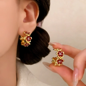 Elegant gold flower C-shaped hoop earrings with deep red enamel and sparkling zircons