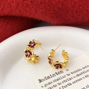 Elegant C-shaped earrings with red enamel flowers and sparkling zircon centers