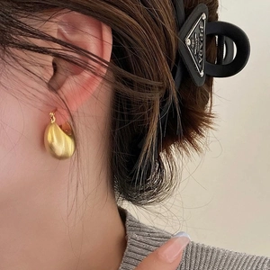 Golden matte brushed geometric ball hoop earrings featuring a minimalist textured design