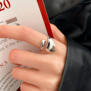 Close-up of minimalist silver irregular open ring with high-polish finish on model
