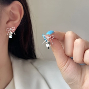 Elegant silver bow stud earrings with dangling round metal sequins for women's fashion