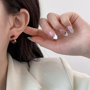 Vintage red and blue enamel earrings for women shown on a model in a luxury style