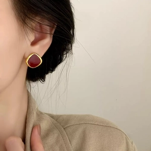 Elegant vintage square earrings in deep red enamel and gold finish on female model