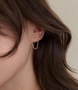 Minimalist gold chain drop earrings and bead stud set shown on model's ear detail