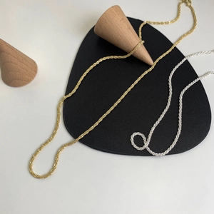 Minimalist geometric chain necklace in gold and silver finish with braided twist design