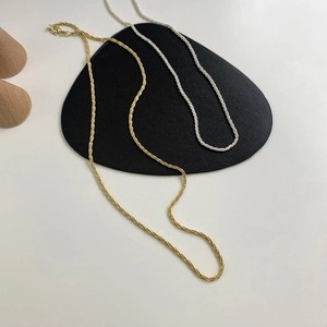 Detailed shot of twisted rope chain necklaces in gold and silver finish with spring clasp