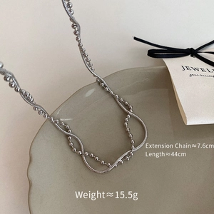 Silver double layer necklace with detailed length measurements shown on a grey tray