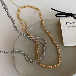 Minimalist double-layered necklace set in gold and silver finish with sleek chain design