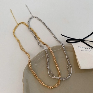 Minimalist double layer wavy necklace in gold and silver finish with snake chain and beads