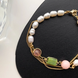 Elegant gold plated chain bracelet featuring freshwater pearls and colorful gemstones