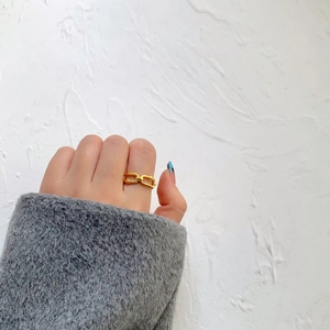 Double-layered twisted gold-plated ring featuring smooth and rope textures on model