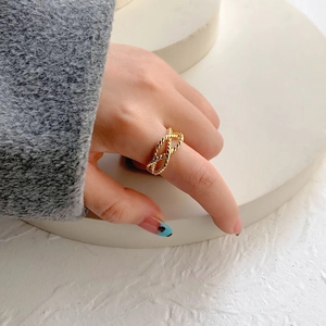 Detail of twisted rope gold plated ring showing intricate double layer textures