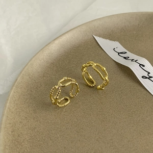 Double-layered twisted gold-plated ring set with irregular texture in a minimalist style