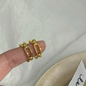 Macro view of gold plated double layer chain and twisted rope rings for women