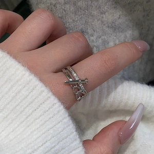 Detailed view of silver nail ring with micro-pave cubic zirconia and chain link