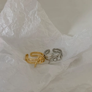 Adjustable nail-shaped rings in gold and silver with pave zircon stones on white paper