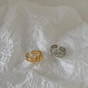 Detail of adjustable hollow nail rings with gold and silver finish and zircon accents