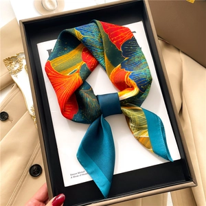 Elegant silk scarf with colorful ginkgo leaf print in a luxury gift box