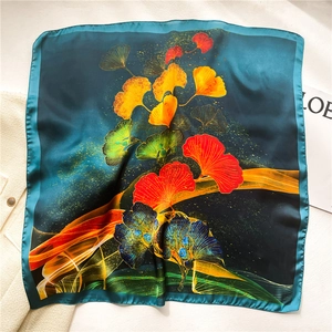 Blue silk square scarf with colorful ginkgo leaf pattern and elegant rolled edges