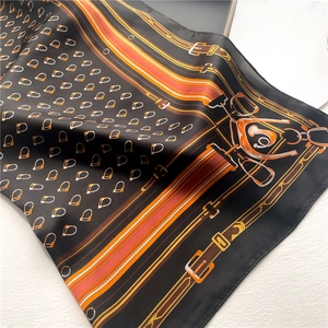 Equestrian chain print silk scarf in black and orange with stirrup pattern