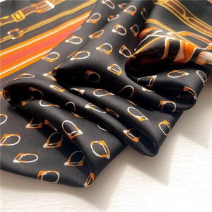Black chain print silk scarf with classic horse harness pattern and orange accents