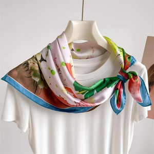 Colorful floral silk square scarf with abstract pattern tied on a white t-shirt neckline
