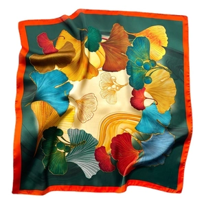 Green silk square scarf with colorful ginkgo leaf patterns and orange borders