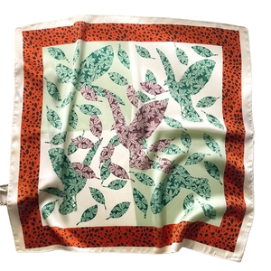 Square silk scarf with bird and leaf patterns and leopard print borders in orange and green