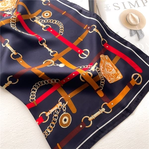 Detail of luxury silk scarf with chain patterns on a stylish magazine display