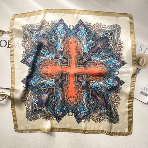 Detailed close-up of retro bohemian paisley silk scarf with vintage floral patterns