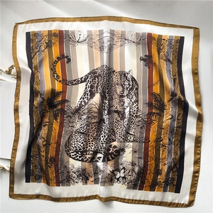 Close-up of leopard and floral print silk scarf with warm earthy tones and stripes