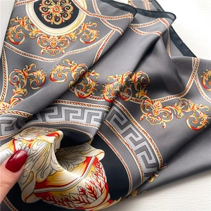 Detail of silk scarf showing vintage baroque patterns and glossy satin fabric texture